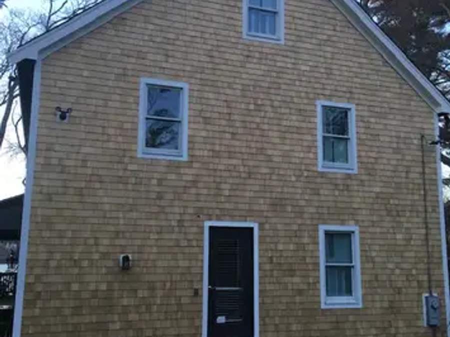 Completed cedar shingle siding on a two-story South Shore home