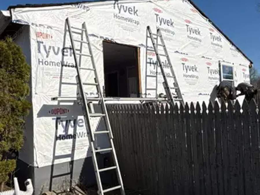 House wrap and staging on a home before new cedar siding