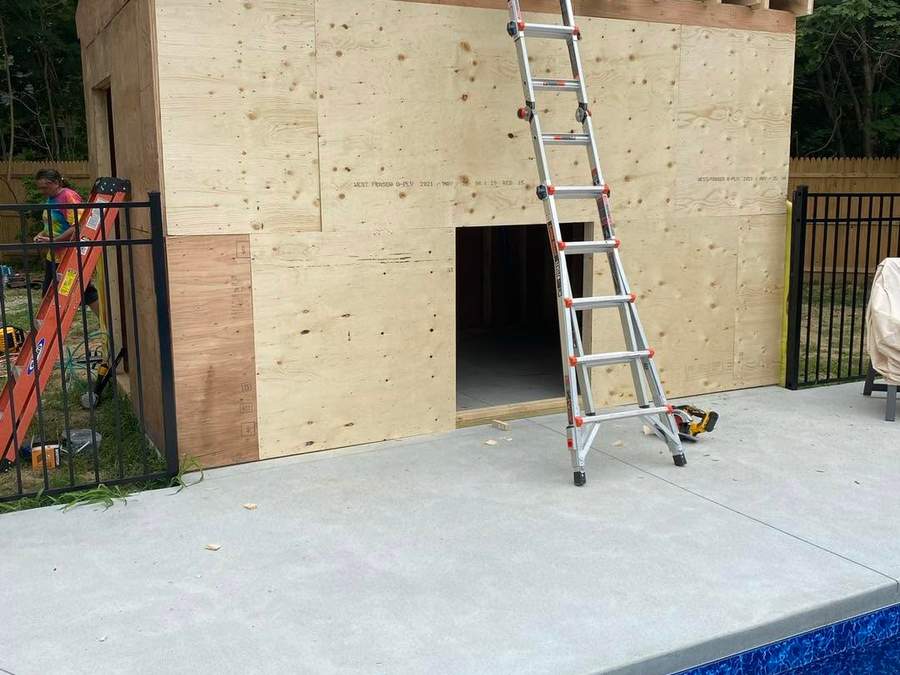 Custom poolside shed framed and sheathed in plywood during construction by CB Builders Corp. on the South Shore
